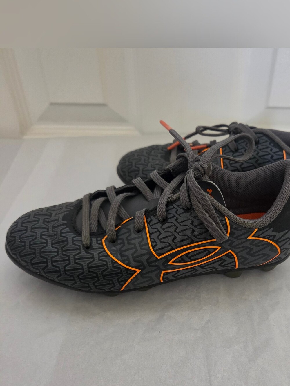 Under Armour Kid’s Gray Soccer Cleats with Orange Accents